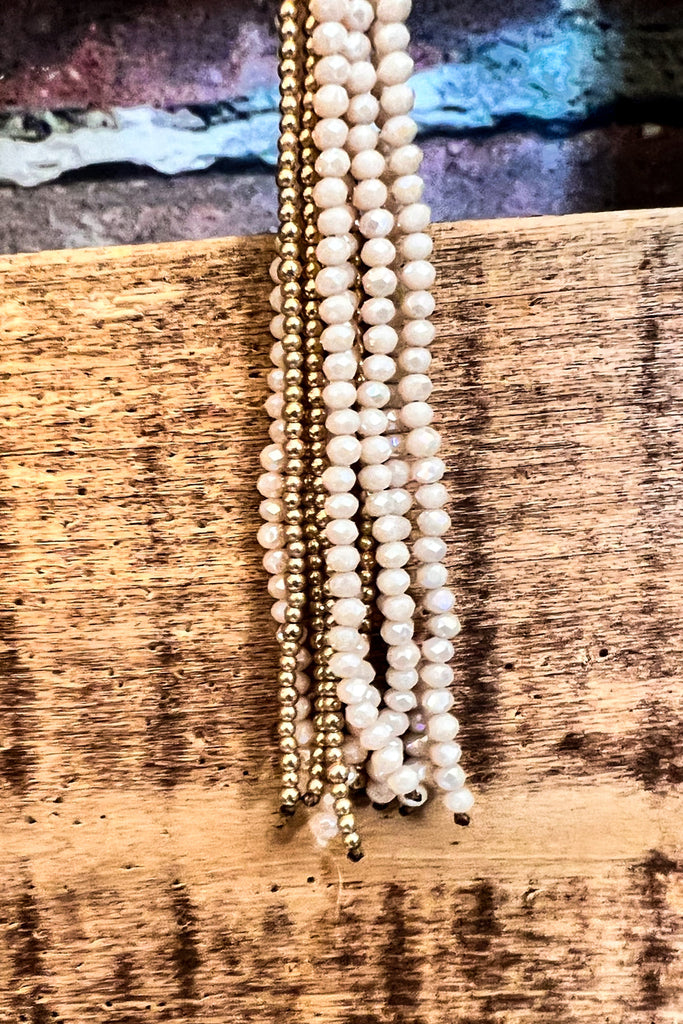CRYSTAL BEADED TASSEL NECKLACE IN BEIGE